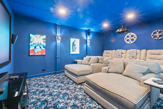 a blue couch sitting next to a blue wall