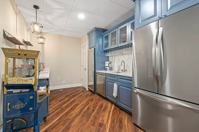 a kitchen with stainless steel appliances a refrigerator and wooden floor