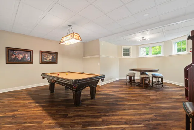 a room with furniture pool table and window