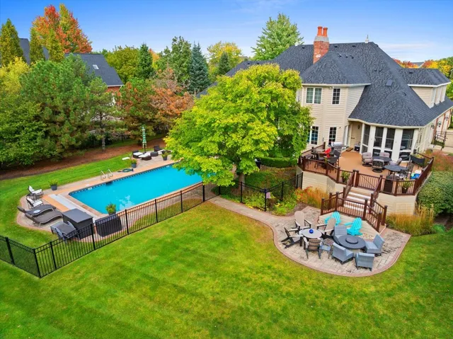 a view of a backyard with plants and outdoor seating