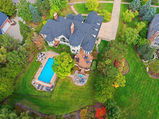 an aerial view of residential house with outdoor space and swimming pool