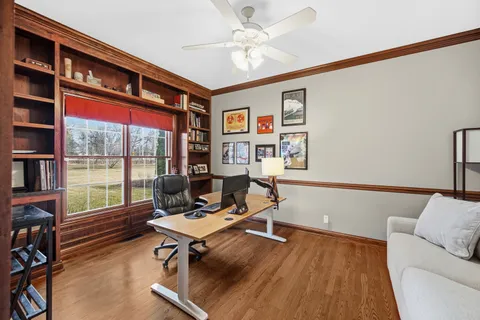 a living room with furniture a rug and a large window