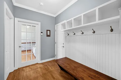 a view of a hallway with wooden floor and closet