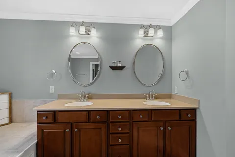 a bathroom with a double vanity sink and a mirror