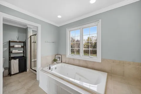 a bathroom with a bathtub and a window