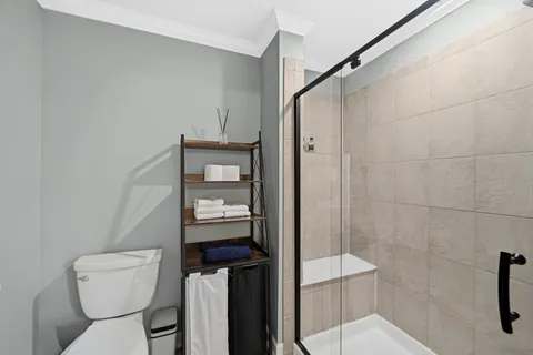 a bathroom with a toilet and a shower
