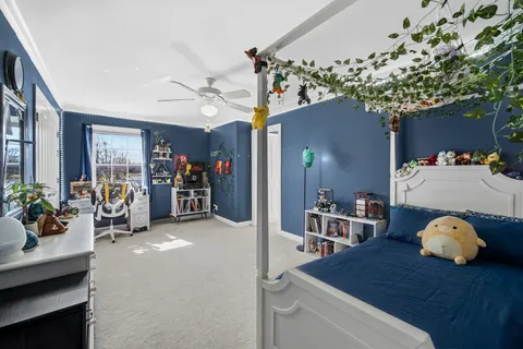 a view of a dining room with furniture and a chandelier