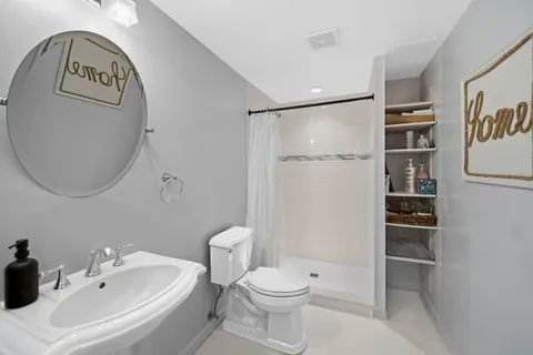 a bathroom with a toilet sink and shower