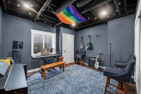 a living room with furniture pool table rug and a window
