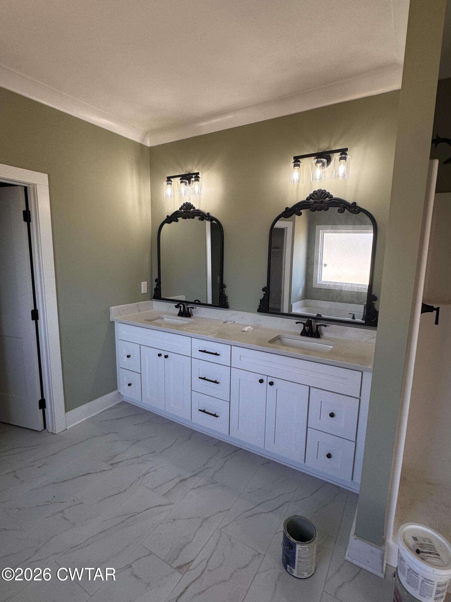 24 Tea Berry Cove Jackson, TN 38305 - Photo 11 of 16 a bathroom with a double vanity sink and a mirror