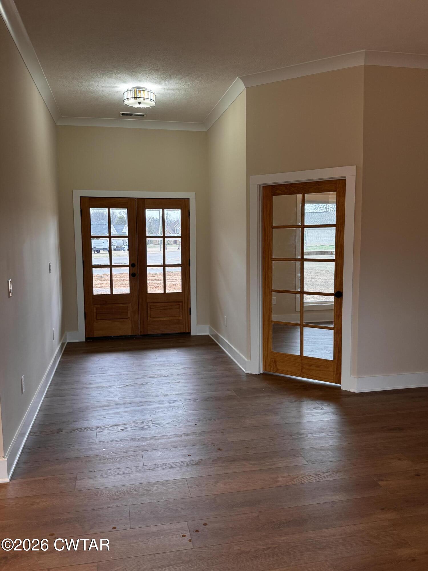 24 Tea Berry Cove Jackson, TN 38305 - Photo 6 of 16 an empty room with wooden floor and windows