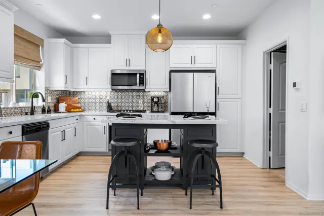 a kitchen with a sink cabinets and window