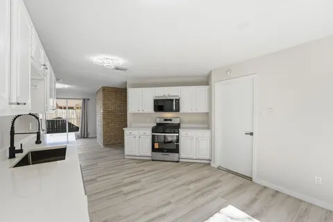 a view of a living room kitchen and a flat screen tv