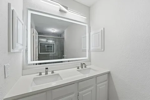 a bathroom with a sink and a mirror