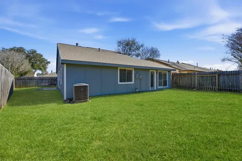 a view of an house with backyard space and garden