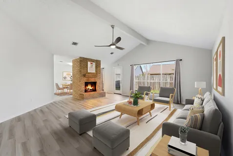 a living room with furniture and a fireplace