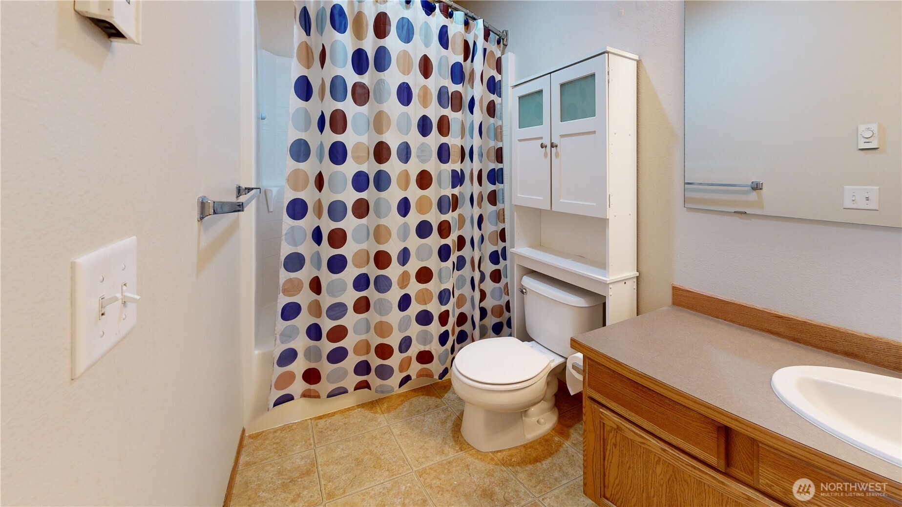 515 Neff Circle Burlington, WA 98233 - Photo 14 of 23 a white toilet sitting next to a shower curtain