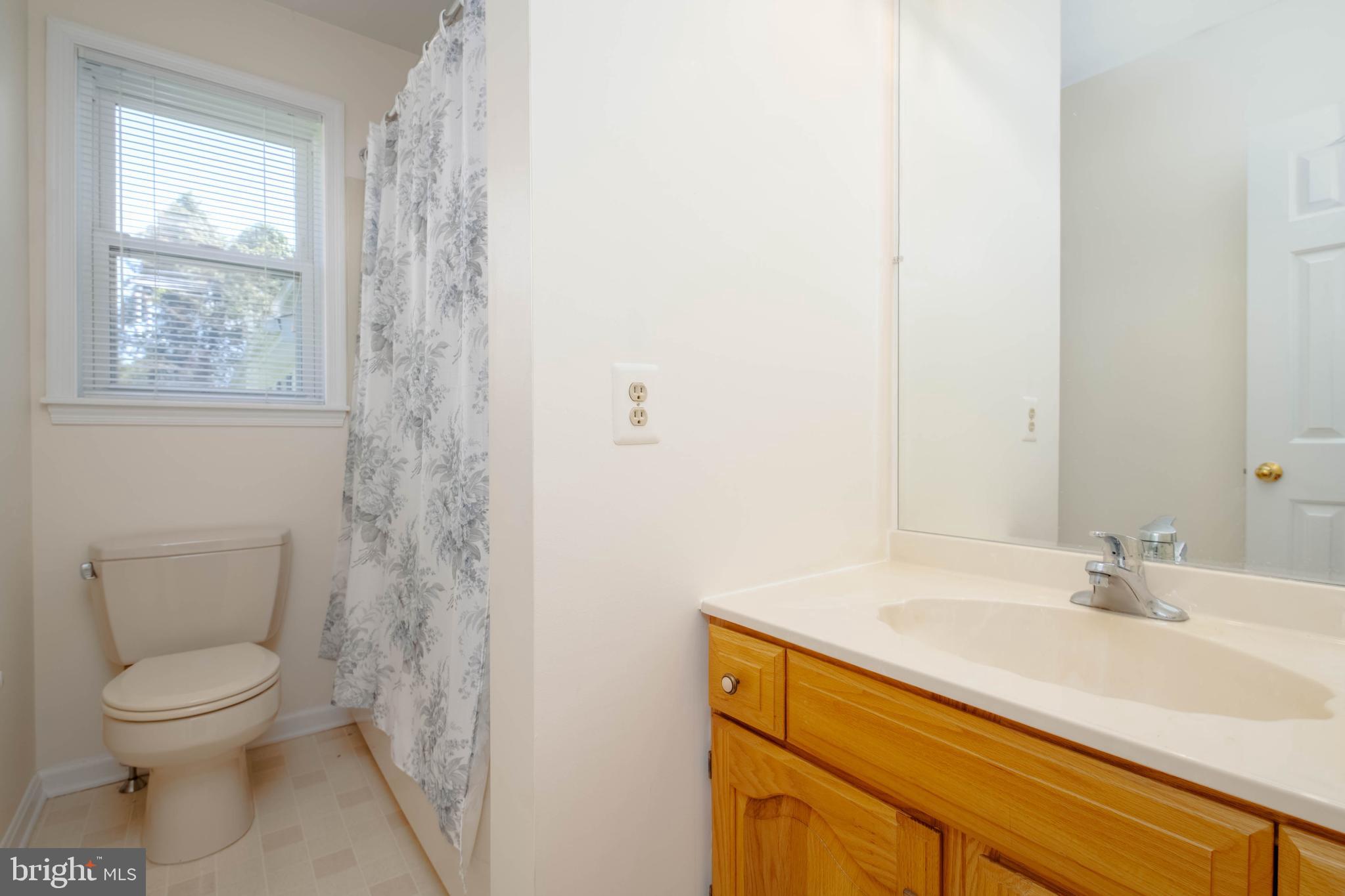 7399 New Cut Road Kingsville, MD 21087 - Photo 28 of 40 a bathroom with a sink a toilet and a window