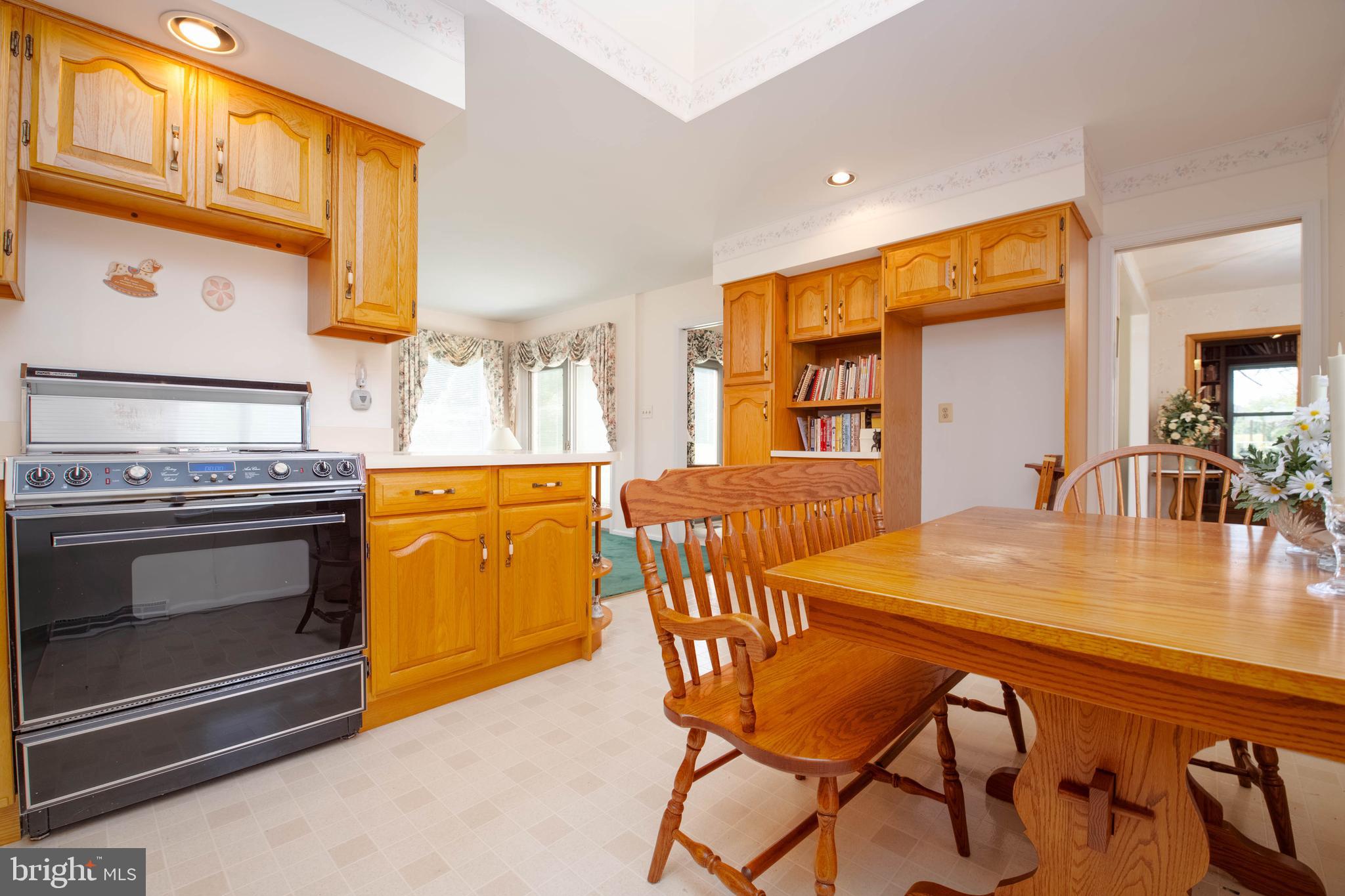 7399 New Cut Road Kingsville, MD 21087 - Photo 8 of 40 a kitchen with a table chairs and a stove