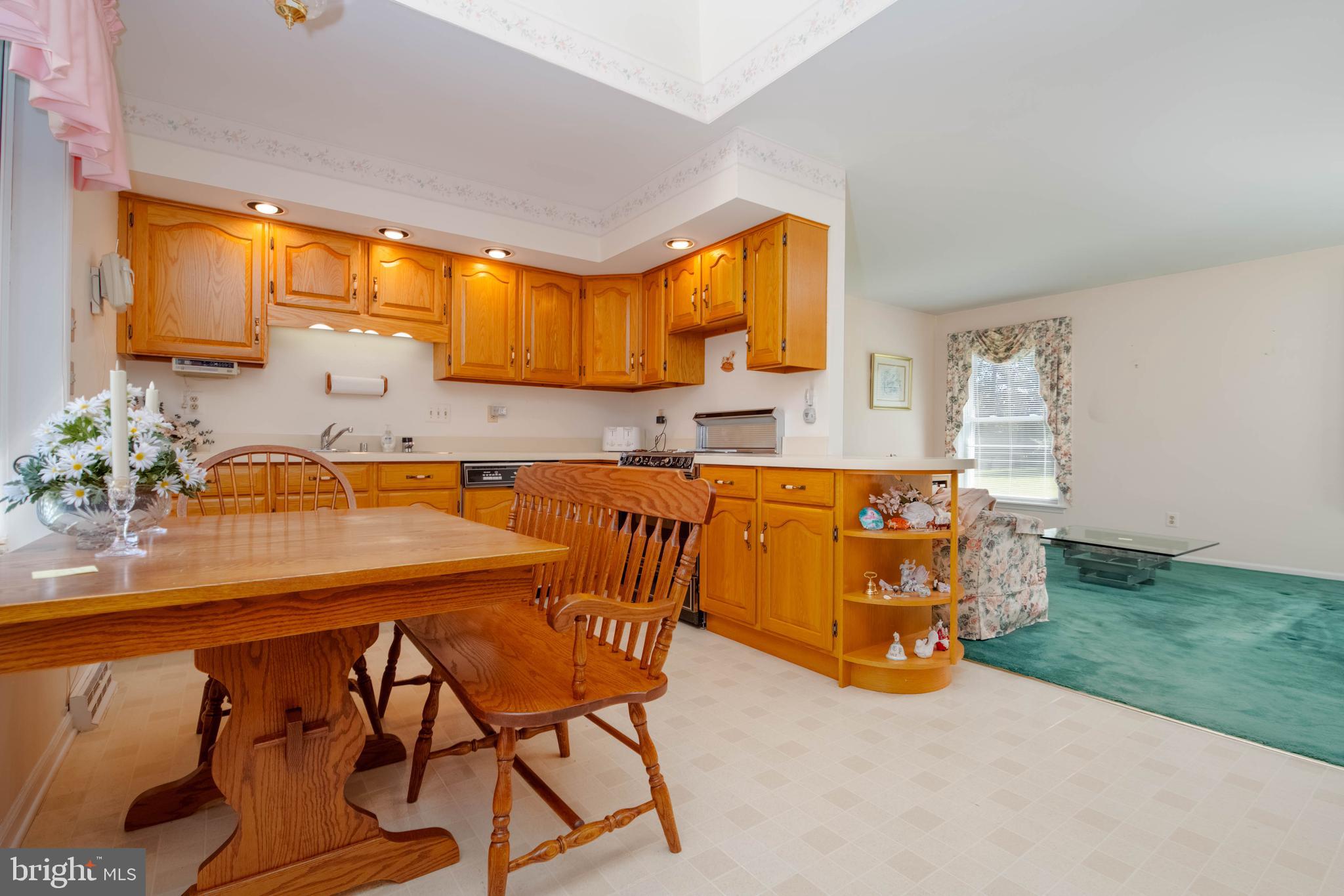 7399 New Cut Road Kingsville, MD 21087 - Photo 9 of 40 a kitchen that has a table chairs in it and wooden floors