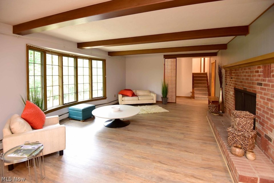 295 River Road Hinckley, OH 44233 - Photo 2 of 25 The welcoming Living Room is generously sized, features a wood burning fireplace, beamed ceilings and an abundance of windows for a wonderful woodland feel.