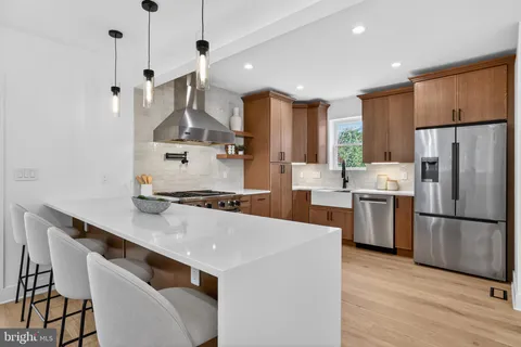a kitchen with refrigerator cabinets and a wooden floor