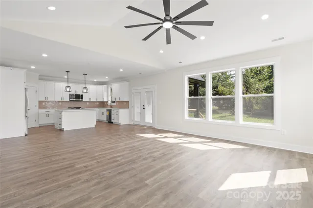 a view of kitchen with wooden floor and windows