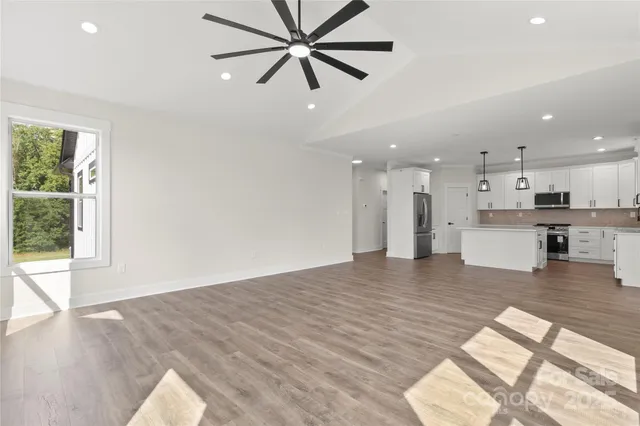 a view of a kitchen with a sink and a window