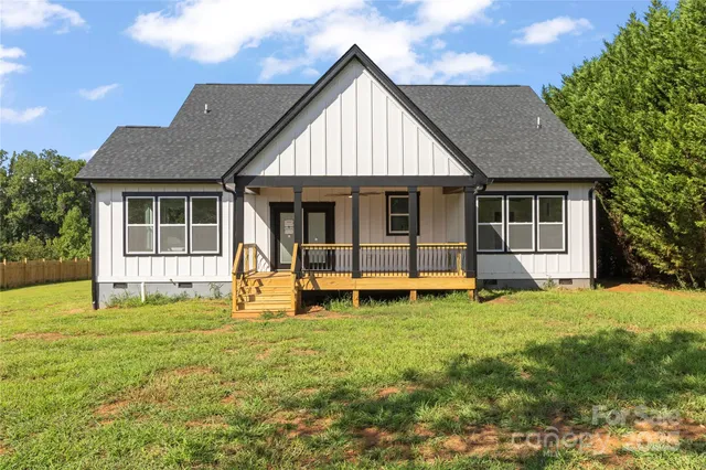 a view of a house with a yard and sitting area