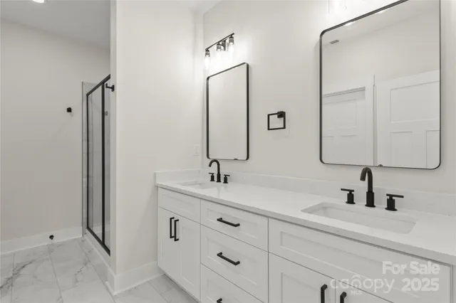 a bathroom with a double vanity sink mirror and
