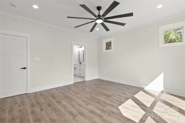 a view of empty room with wooden floor