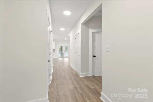 a view of a hallway with wooden floor