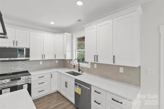 a kitchen with white cabinets and white appliances