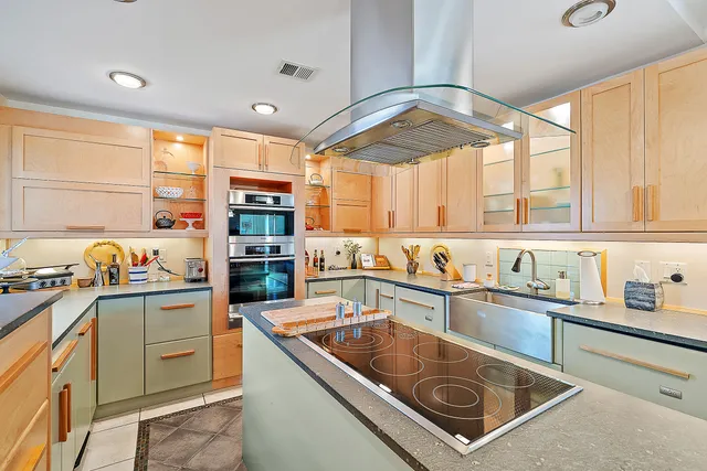 a kitchen that has a sink and a stove top oven