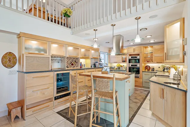 a kitchen with a stove cabinets and a fireplace