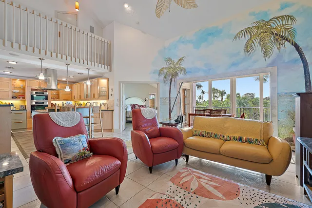 a living room with furniture and a floor to ceiling window
