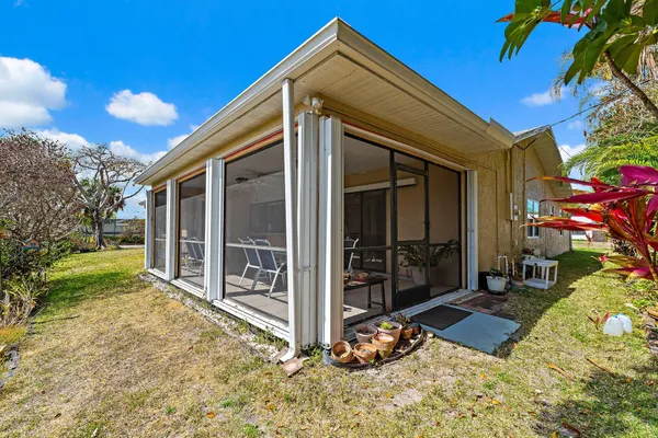 a view of a house with a yard and tree s