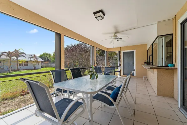 a view of a dining room with furniture large windows and wooden floor