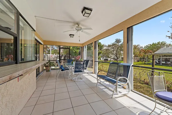 a view of a house with a patio and a yard