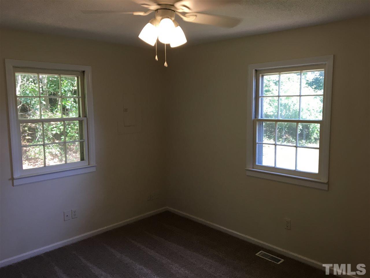689 Silas Moore Road Coats, NC 27521 - Photo 11 of 17 an empty room with a window