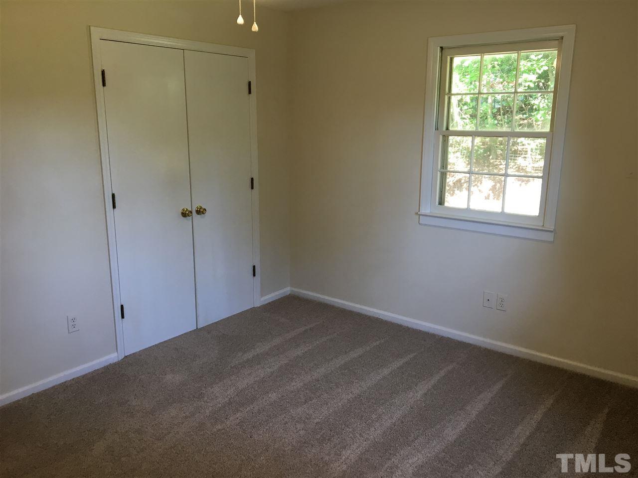 689 Silas Moore Road Coats, NC 27521 - Photo 12 of 17 a view of an empty room with a window
