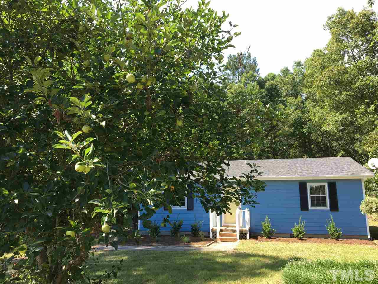 689 Silas Moore Road Coats, NC 27521 - Photo 17 of 17 a front view of a house with a garden