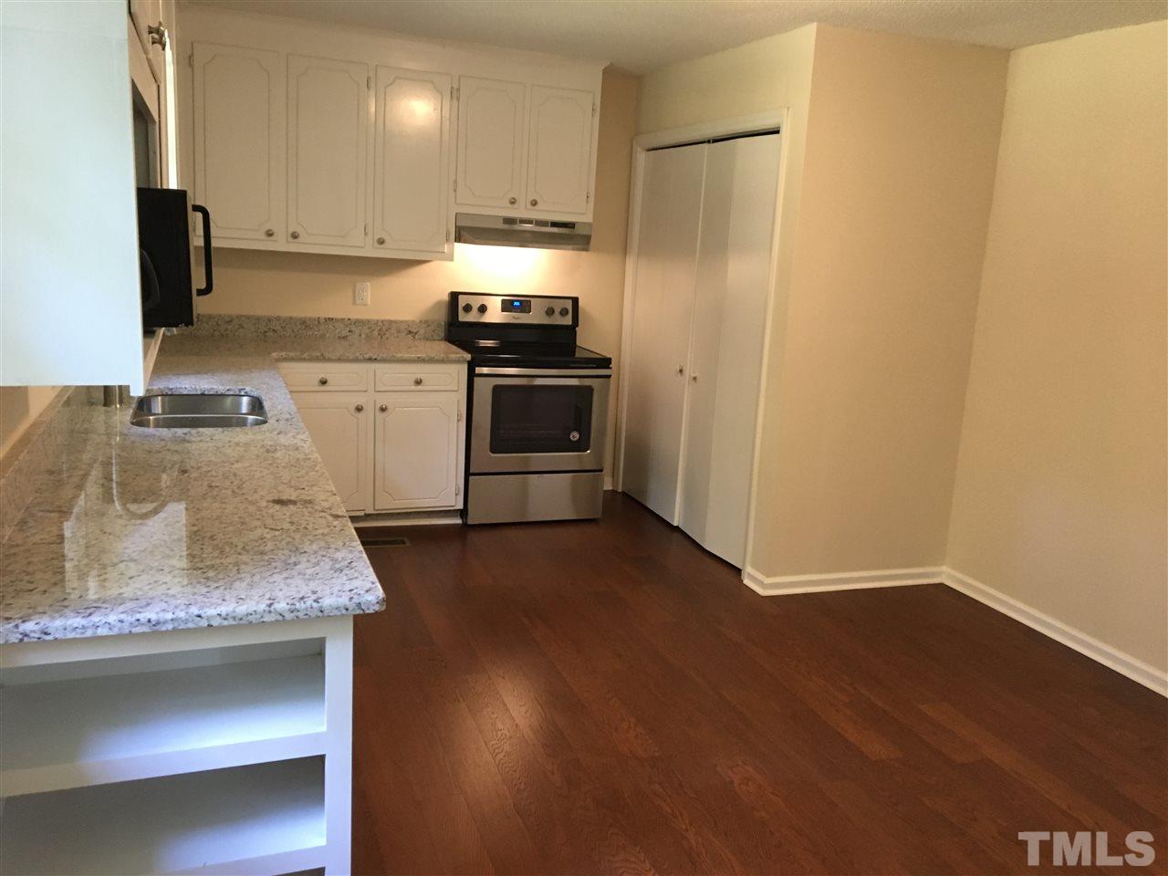 689 Silas Moore Road Coats, NC 27521 - Photo 6 of 17 a kitchen with stainless steel appliances granite countertop a sink stove and refrigerator