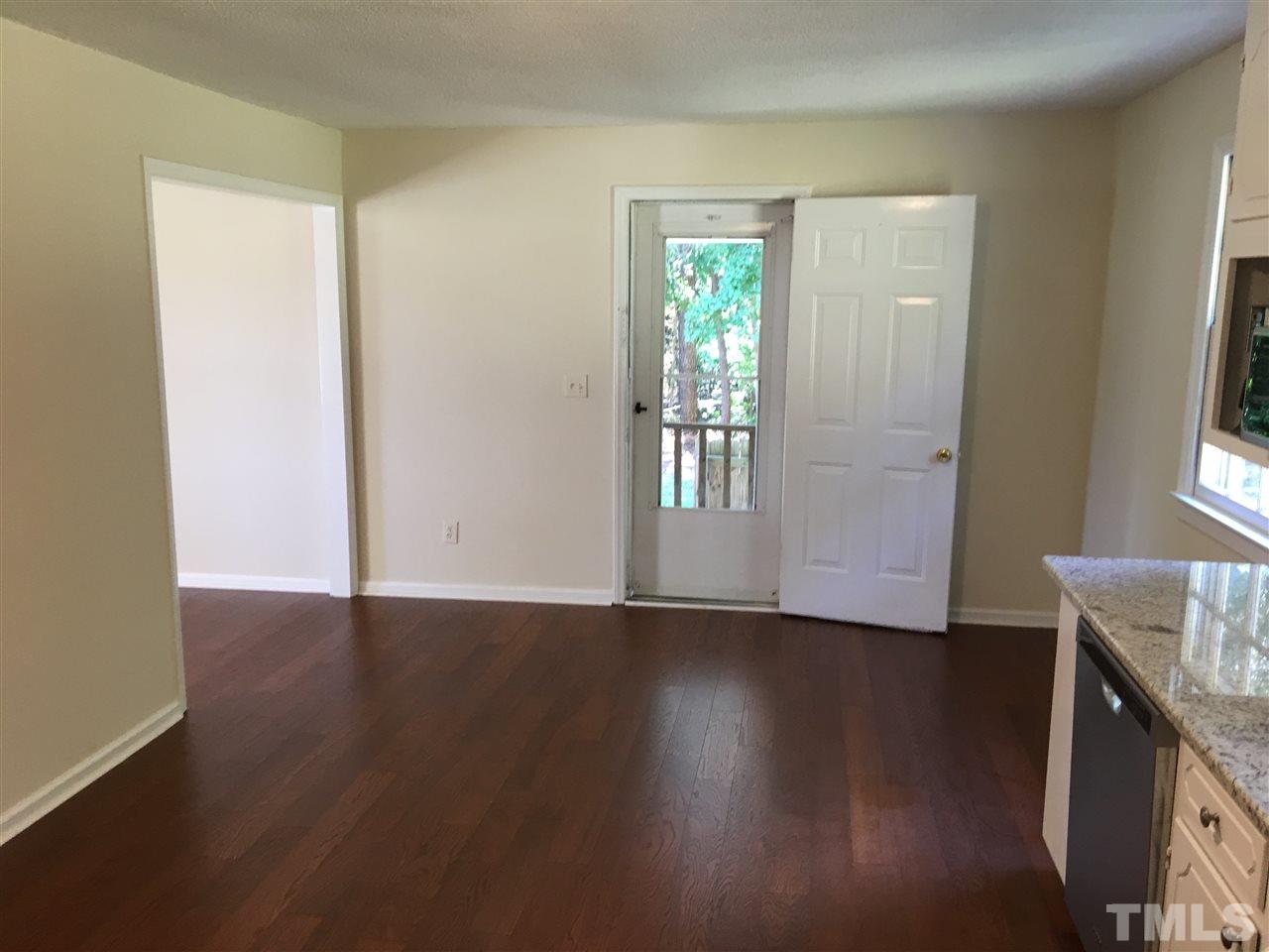 689 Silas Moore Road Coats, NC 27521 - Photo 7 of 17 a view of an empty room with wooden floor and a window