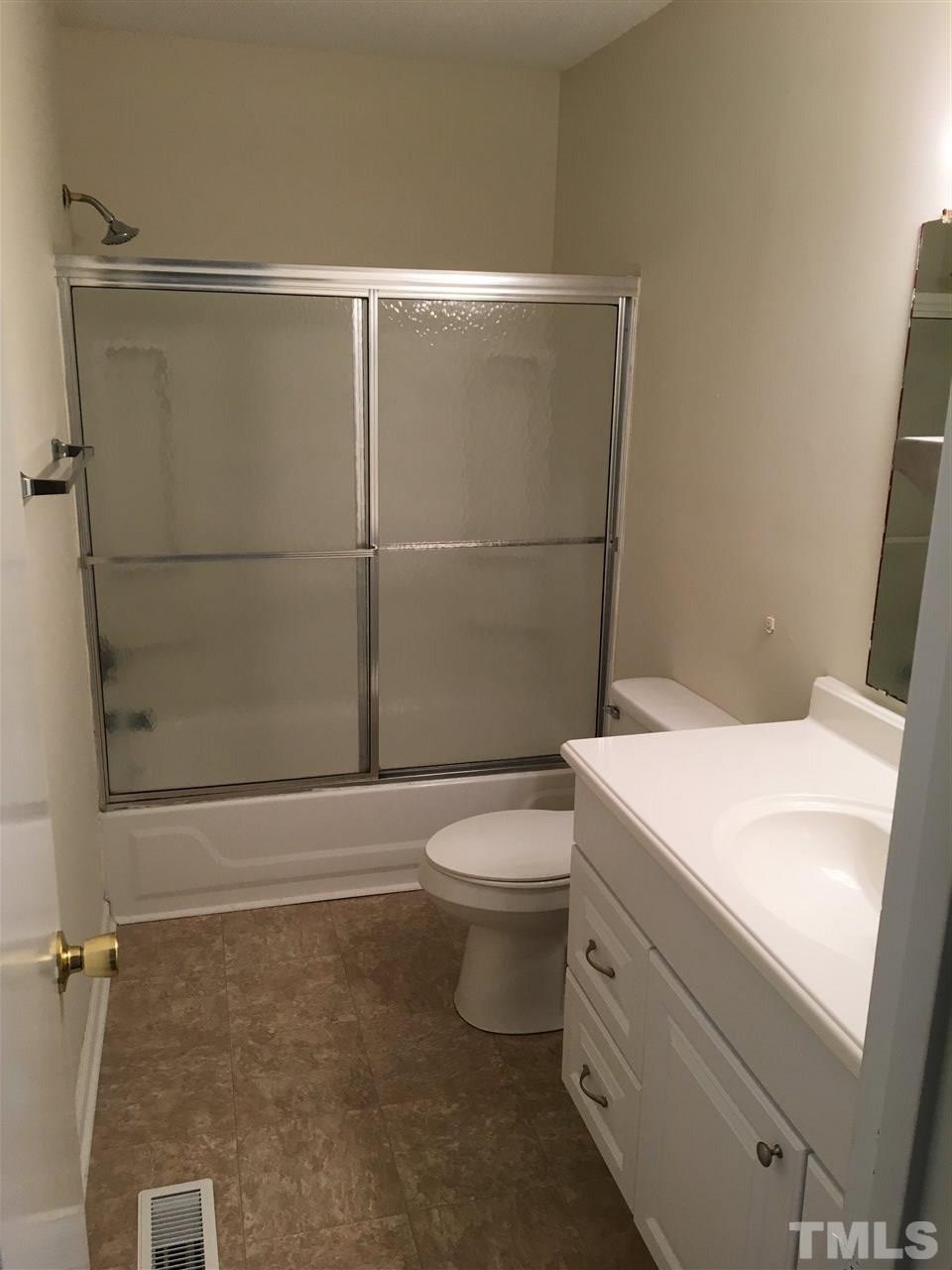 689 Silas Moore Road Coats, NC 27521 - Photo 8 of 17 a bathroom with a toilet and a shower