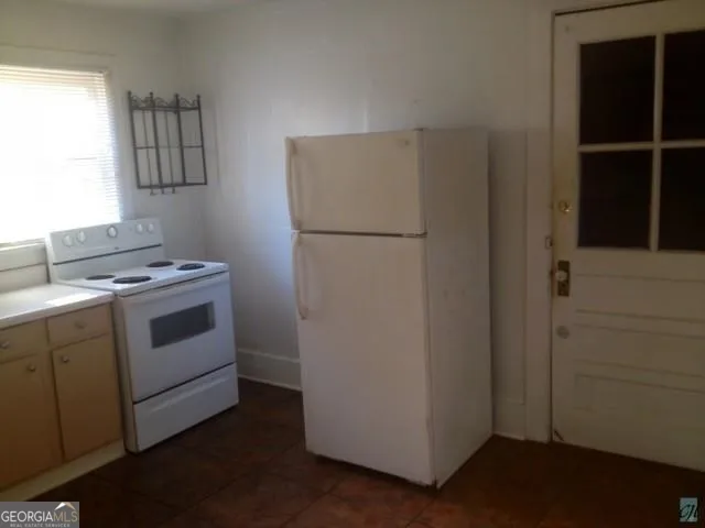 a kitchen with a stove and a refrigerator