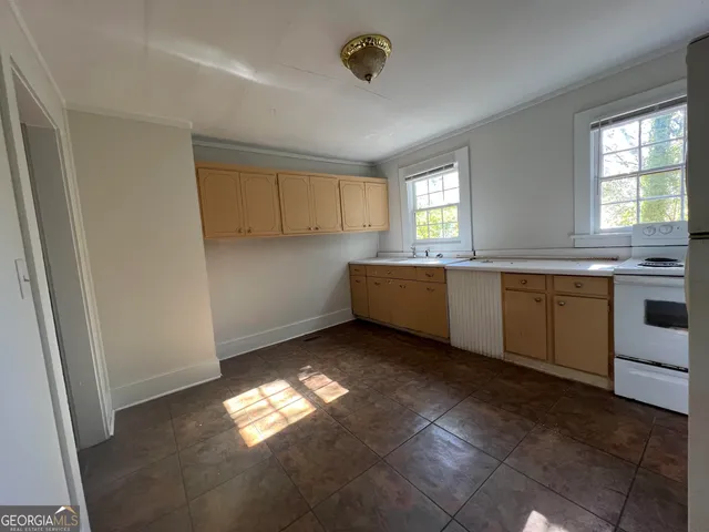 a kitchen with cabinets and window
