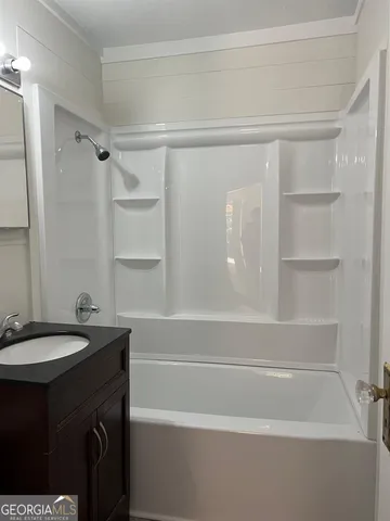 a bathroom with a sink a toilet and a shower