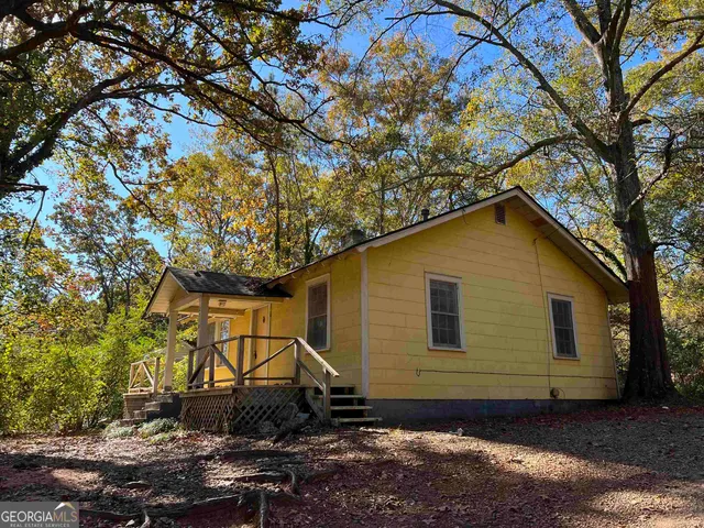 a backyard of a house with lots of trees