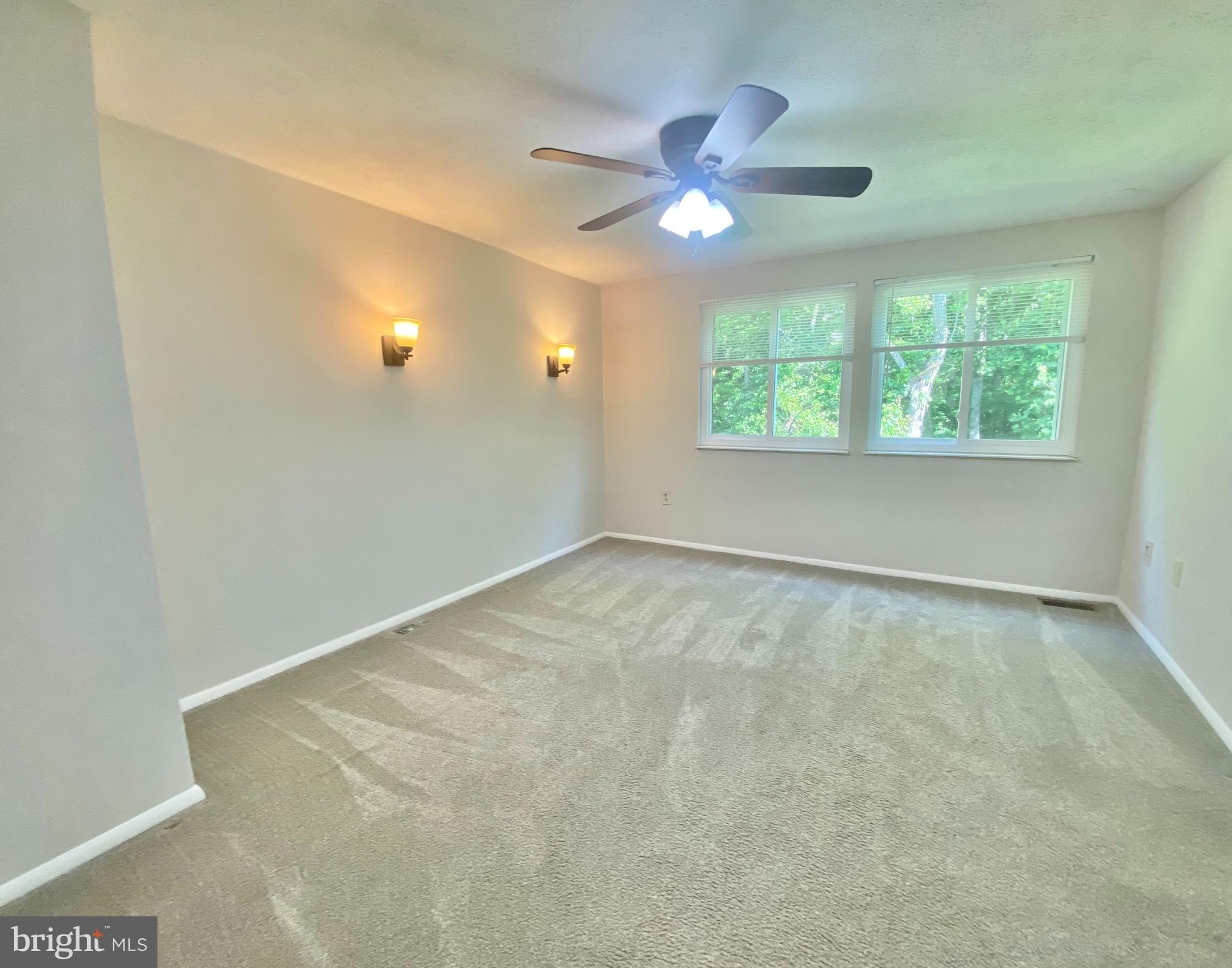 6212 Hillside Road Springfield, VA 22152 - Photo 19 of 36 Primary bedroom with ceiling fan and sconces